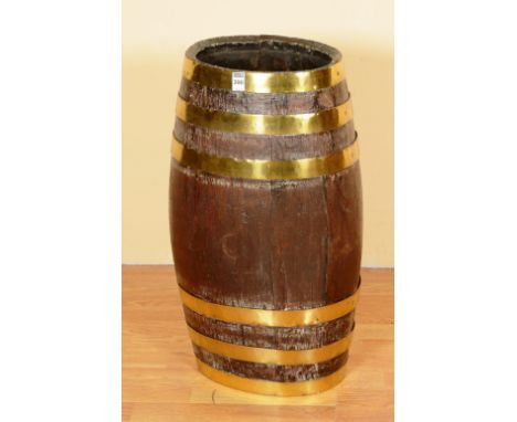 An oak barrel stick stand, bound in brass, 62cm high x 28cm wide