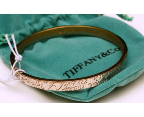 A modern Tiffany & Co silver bangle, stamped 925, with pouch and box, 6cm diameter