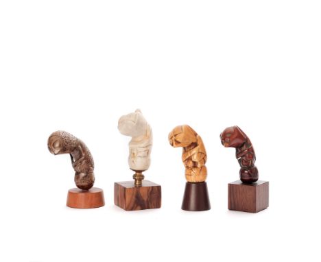 Sumatra, four kris hilts, two marine ivory, a tridacna gigas and a wooden jawa demam hilt. H. 7,5; 7,7; 8 and 8,2 cm. resp, a