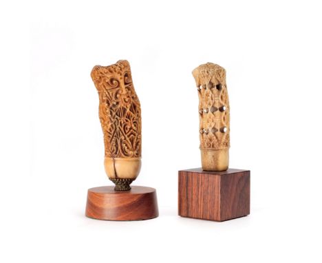 Java, North Coast,two kris hilts, one depicting a floralised ancestor, the other deer horn with four registers of stylised fl