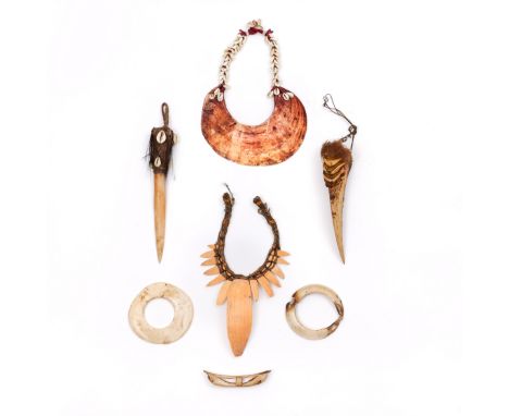 P.N. Guinea, Mendi, shell pectoral and an Abelam tridacna shell currency. Herewith a bone dagger, Mendi necklace, bone nose o