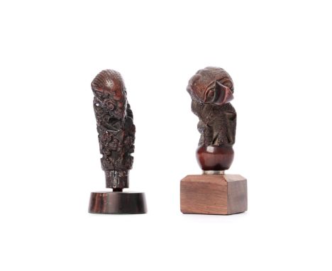 Java, two wooden kris hilts, one showing a bird shaped handle, the other showing a floralised elephant. H. 8,4 and 9,3 cm. [2