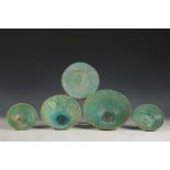 Persia, four thinly potted turquoise glazed pottery bowls and a saucer, 13-16th century,