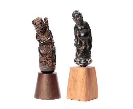 Bali, two wooden togonan kris hilts, one depicting baby Bay, silvered selut, the other a demonic figure with club and garuda 