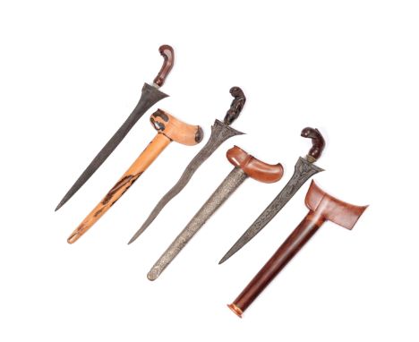 Java, two krisses, one Cerebon with wooden hilt, mendak set with inten, five luk pamor blade, repousse silver pendok, the Sol