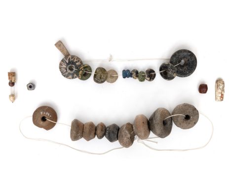 A collection of antique terracotta, stone and glass beads, a stone hand axe and two stone axe heads, ca. 3000 BC. various siz