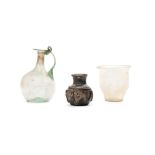 A fine Roman glass jug with handle, a fine Roman flass goblet and a black Roman glass flask, ca. 3rd