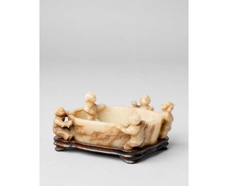 A CHINESE MOTTLED CELADON JADE 'BOYS' BRUSH WASHERQING DYNASTY OR LATERCarved with four playful boys climbing the sides, one 