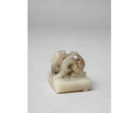 A CHINESE GREY JADE 'DRAGON' SEALQING DYNASTY OR LATERThe finial carved as a single crouching dragon, the seal face carved wi