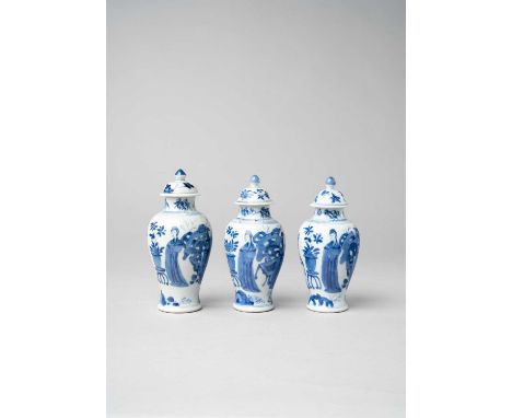 THREE SMALL CHINESE BLUE AND WHITE VASES AND COVERSKANGXI 1662-1722Each of slender baluster form, painted with a continuous s