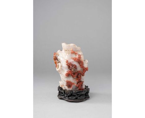 A CHINESE CHALCEDONY 'PRUNUS' BRUSHPOT, BITONGQING DYNASTYFormed as a section of a hollowed tree trunk detailed with knots an