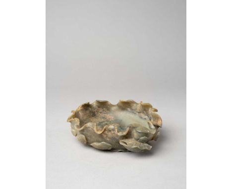 A LARGE CHINESE JADE 'LOTUS' BRUSH WASHER19TH CENTURYThe mottled grey celadon-coloured stone carved as a large lotus leaf, su