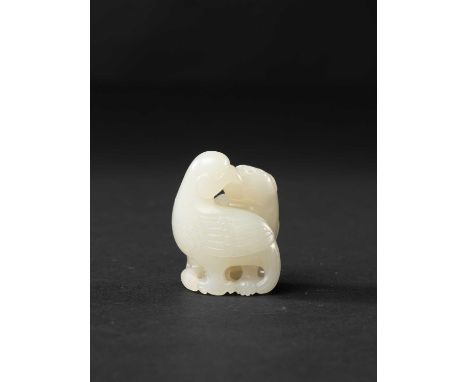 A SMALL CHINESE PALE CELADON JADE CARVING OF A MYTHICAL BEAST AND AN EAGLELATE QING DYNASTYThe stylised beast sitting on its 