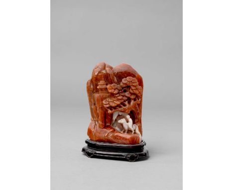 A CHINESE CARNELIAN BOULDER CARVINGQING DYNASTY OR LATERCarved with an equestrian figure below a steep cliff face beneath a p