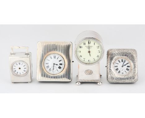 Silver carriage time piece, two silver watch stands with Goliath watches various dates and makers, and a silver plated clockC