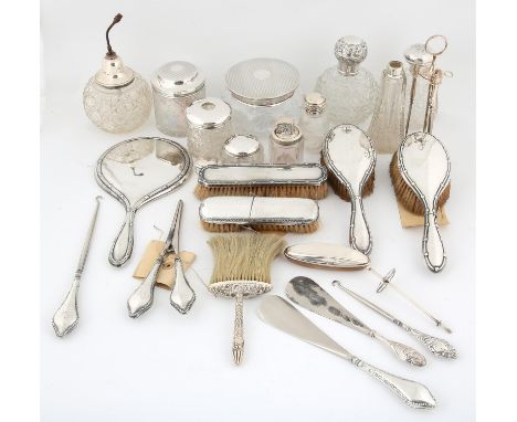 Silver mounted dressing table items to include, scent bottles, button hooks, brushes, and ring stand