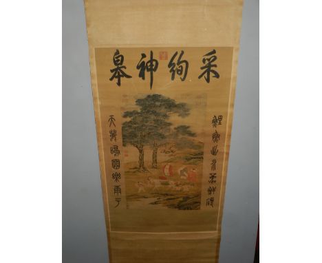 A Chinese quilted scroll, decorated with figures amongst a stylised landscape. 