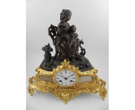 A late 19th century French bronzed spelter and gilt metal mantle clock, altered with later additions.