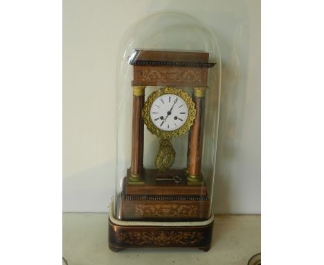 A mid 19th century French portico mantle clock, having a rosewood and ormolu mounted architectural case, with foliate marquet