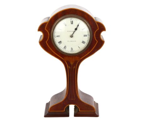 An Edwardian Art Nouveau mahogany-cased mantel clock of highly stylised form, with inlaid floral motif and stringing, by Edwa