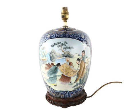 A Chinese porcelain lamp base on carved wood stand, height excluding fitting 32cm 