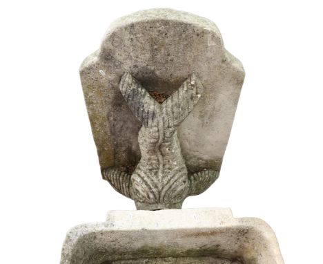 A weathered reconstituted stone gurgle fish design wall fountain and basin, basin width 72cm