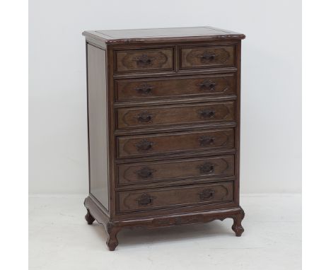 A Chinese style carved mahogany commode with seven drawers, measuring 70x50cm, H104cm, late 20th century.