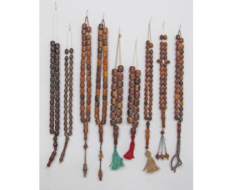 A collection of nine brown amber colour, worry beads / kombologia / rosary. From left to right: [brown cylindrical - 34g - 36
