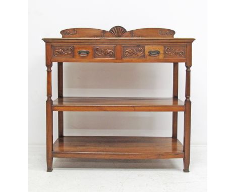 An Art Deco carved walnut dresser with two frize drawers above two shelves, measuring W120cm, D52,5cm, the top shelf H111cm a