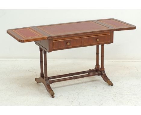 A Chippendale style faux bamboo drop leaf extending games table with a red leather top above two frieze drawers standing on t