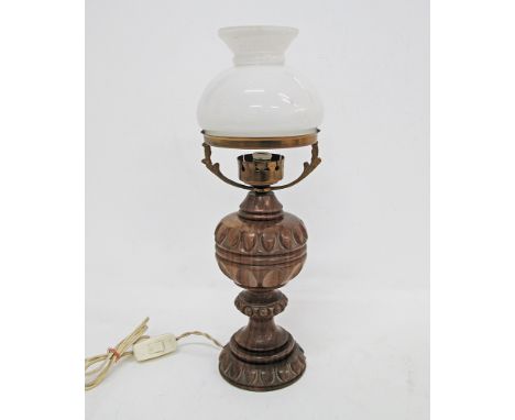 A table lamp with a carved wood body and a white opaline glass shade H40cm, mid century.