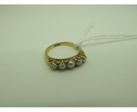An Antique Five Pearl Ring, of graduated design with diamond chip highlights (two missing), within scroll carved setting, sta