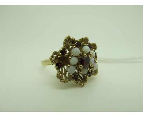 A 9ct Gold Garnet and Opal Set Cluster Dress Ring, of abstract design, claw set (finger size Q) (6.5grams). 