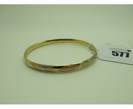 A Modern Three Colour Bangle, of part Harlequin design, to snap clasp, stamped '585' (9.5 grams).