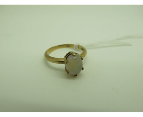 An Opal Single Stone Ring, oval cabochon claw set, stamped "9ct" (finger size N). 