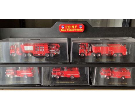 Code 3: A collection of five cased FDNY Suoer Pumper System fire engine vehicles, all upon black display shelf. Five engines 