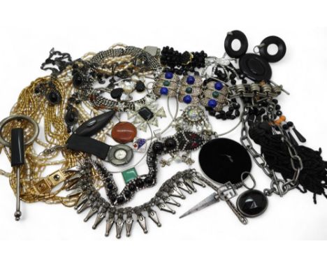 A wicker case full of costume jewellery to include, statement beads and necklaces, a silver torc with mabe pearl and labrador
