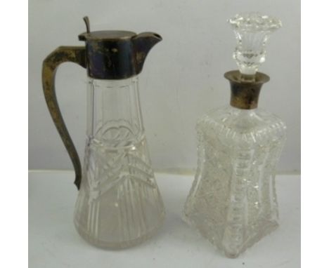 AN EDWARDIAN SILVER MOUNTED CUT CRYSTAL GLASS CLARET JUG having plain hinged lid cover with angular shouldered thin sweeping 