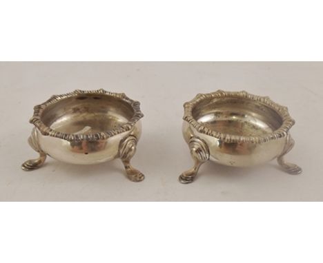 JAMES DEAKIN & SONS A PAIR OF GEORGIAN STYLE SILVER SALTS each having cast fancy gadroon rim, raised on three hoot feet, Shef
