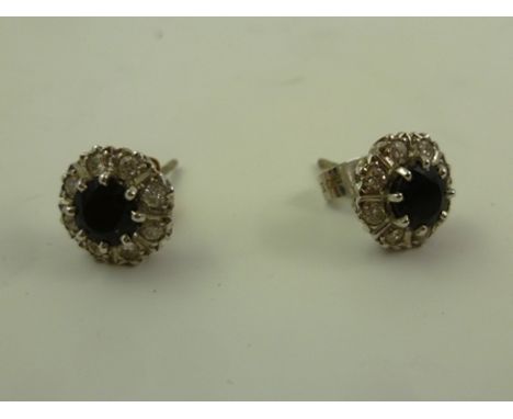 A PAIR OF SAPPHIRE AND DIAMOND EAR STUDS in rhodium finished white gold claw setting with butterfly clasp 