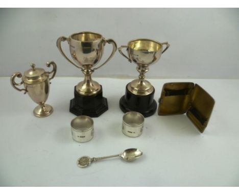 J** S** A PAIR OF SILVER NAPKIN RINGS with bright cut decoration, unengraved, Sheffield 1915 and three silver trophy CUPS, TE