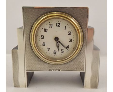SANDERS AND MACKENZIE AN ART DECO DESIGN SMALL MANTEL CLOCK, silver faced with engine turned decoration, Birmingham 1930, 10c