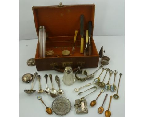 A SMALL LEATHER SUITCASE AND CONTENTS including a silver napkin ring, various silver appointments and collector's items 