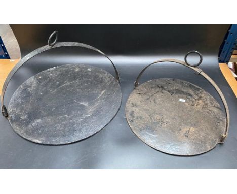 A collection of two antique cast iron cooking skillet's [46cm diameter] 