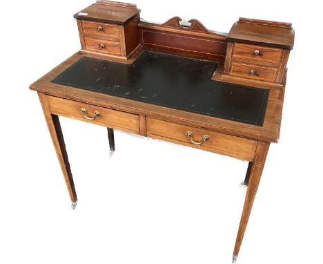 Edwardian inlaid  desk, the central panel flanked by two banks of short drawers, the leather top surface above two longer dra