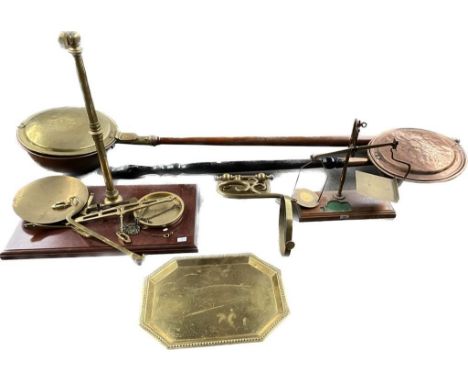 A collection of two brass weighing scales, brass wall mounted oil lamp fixture along with two brass bed warmers 
