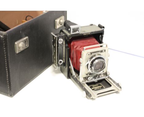 A Graflex 23 hand camera: Centuary Graphic 23 with an f/3.5 105mm Xenar lens, roll film back and dark slides in fitted case