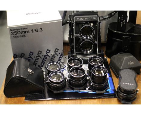 A Mamiyaflex C330f and lenses Mamiyaflex C330f camera with 55, 65, 80, 105, 135 180 and 250 lenses and accessories in a metal