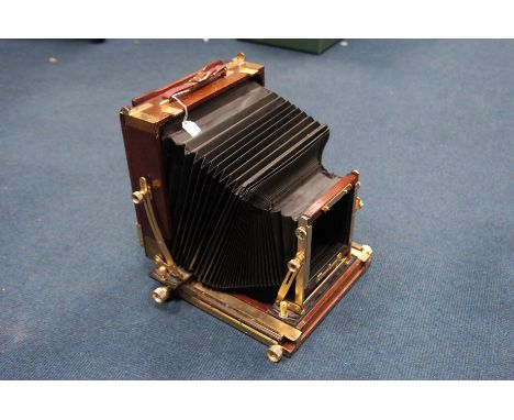 A Mahogany 10x8 Field Camera, wood and brass construction with double extension bellows