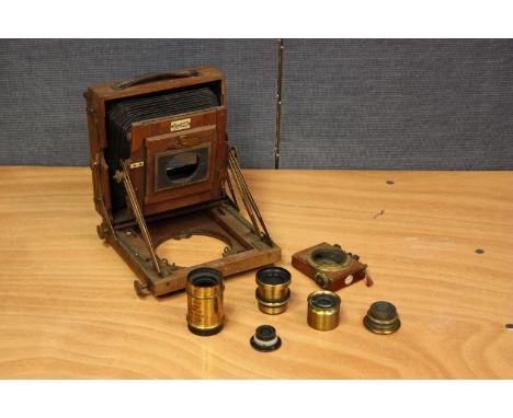 A Sanderson Half Plate Mahogany Field Camera, with four brass lenses and an Wray example (a lot)